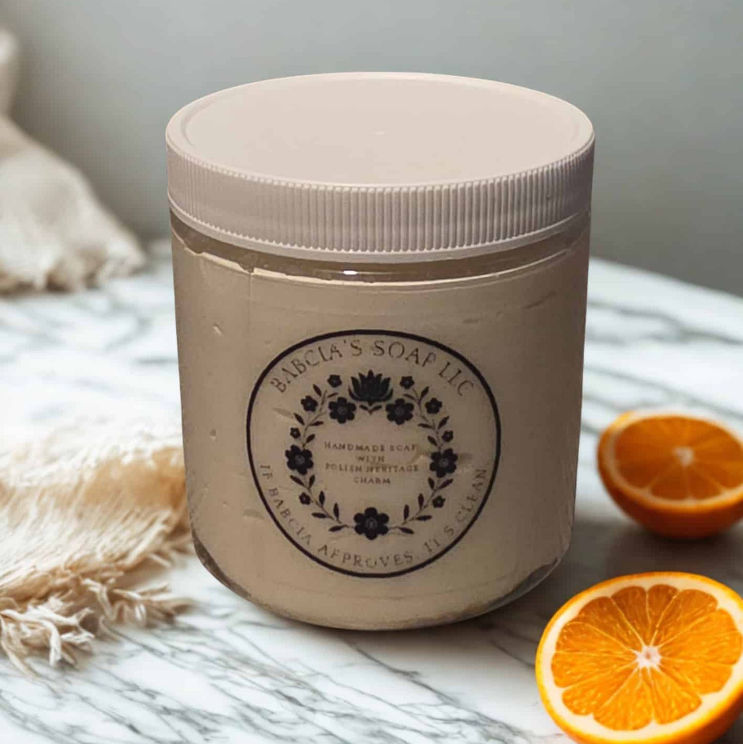 Jar of whipped sugar scrub in orange
