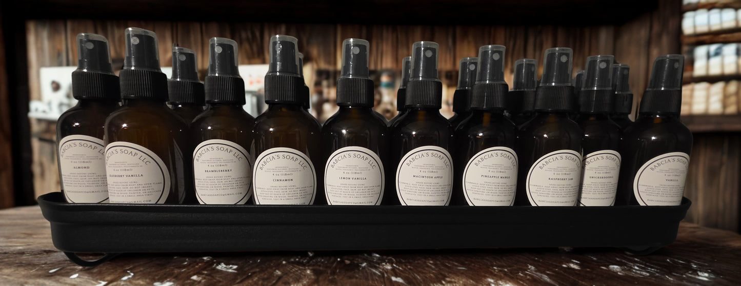 Row of brown spray bottles with black nozzles on a wooden surface.