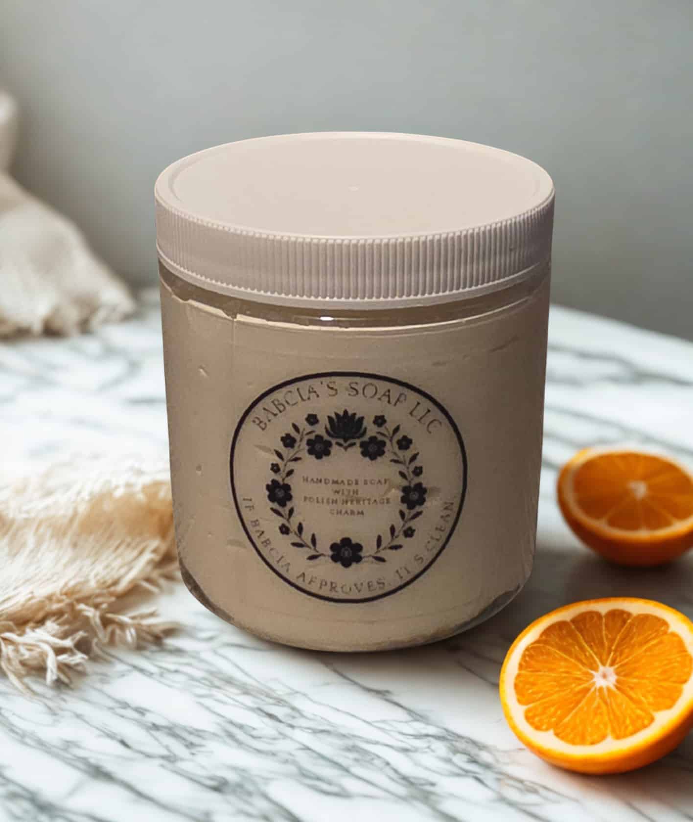 Jar of whipped sugar scrub in orange